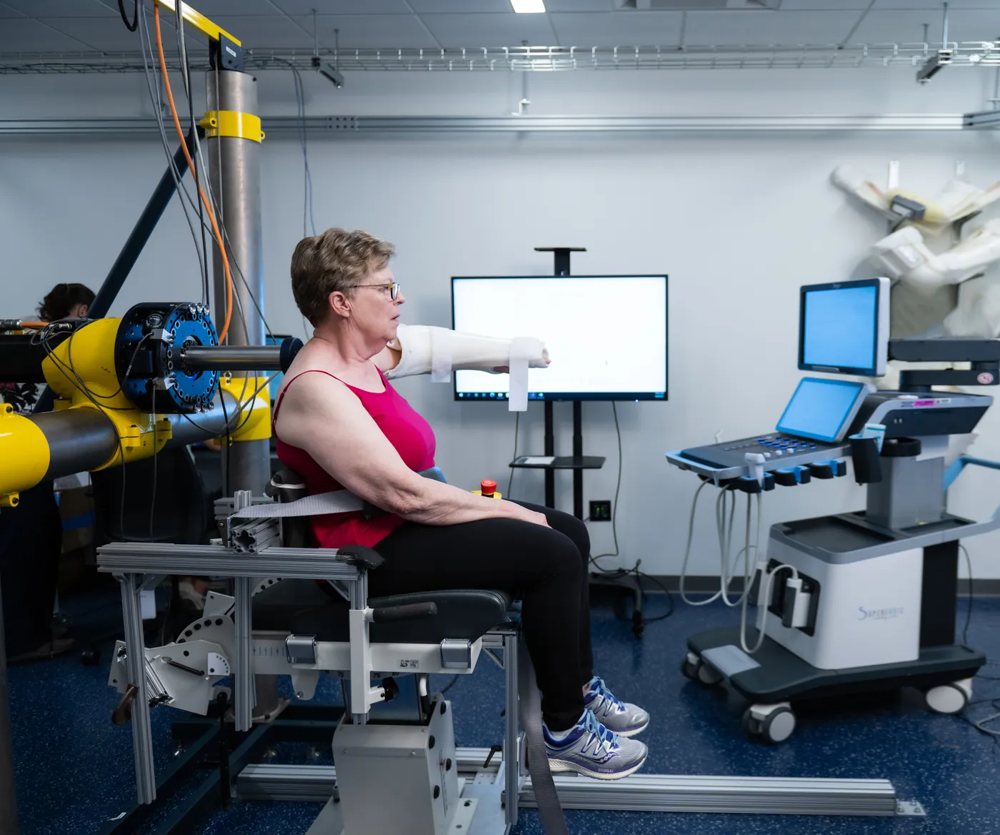A participant performs a seated shoulder assessment with a robotic manipulandum in the MBIL laboratory.